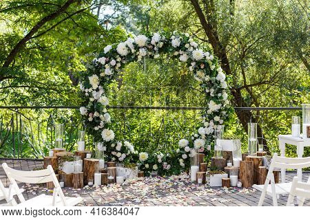 Nature Theme In Wedding Ceremony Decoration. Newlyweds Arch Decorated In Rustic Style