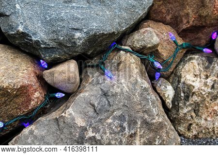 Landscaping Lights Placed Between Bolder And Rocks