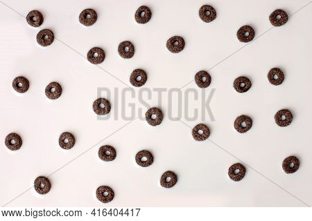 A Lot Of Black Rings Cerial In White Milk, Breakfast Background. Crispy Corn In Milk, Flyer, Banner 