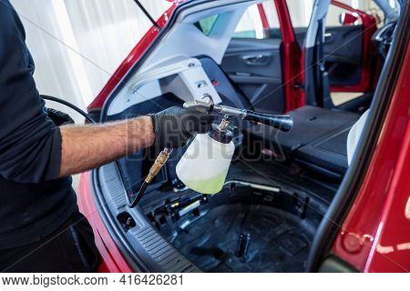 A Car Service Worker Cleans Interiror With A Special Foam Generator