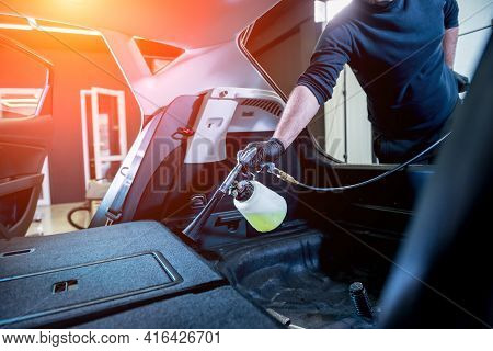 A Car Service Worker Cleans Interiror With A Special Foam Generator