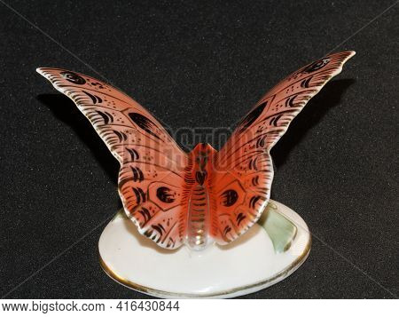 Porcelain Butterfly Figurine Isolated On Black Background