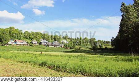 Village Panorama Spring - Spacious Green Meadow, Blue Sky With Clouds,old Style Houses. With Copy Te