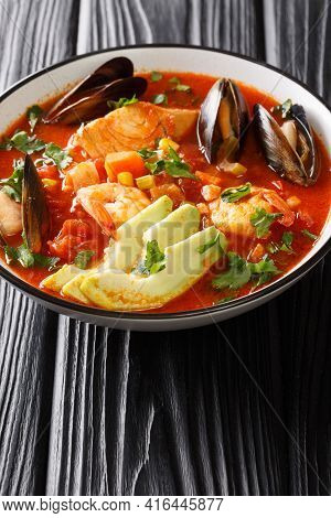 Sopa De Mariscos Tomato Soup With Seafood And Vegetables Close-up In A Bowl On The Table. Vertical