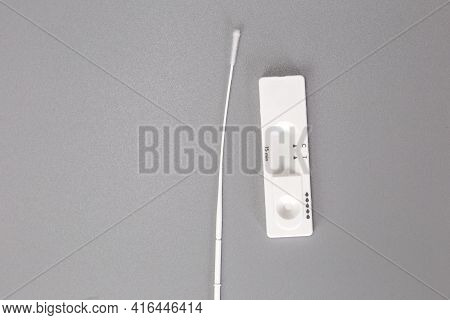 Rapid Self Test Covid-19 With Nose Swab, Home Test Kit For Coronavirus Top View On Gray Background W