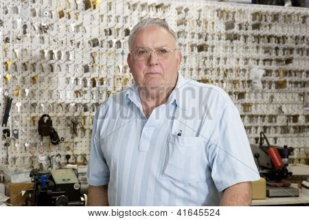 Portrait of a senior male owner of key store