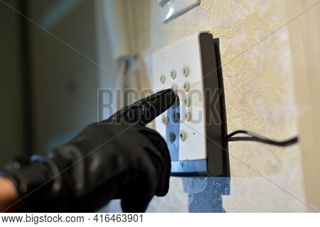 Mans Hand Dials The Code From The Security System At Home On A Keypad With Numbers From Theft And Bu