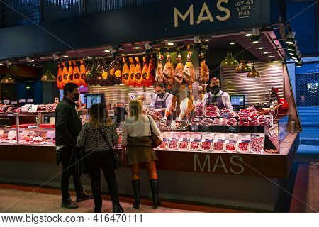 Spain, Barcelona, January, 2021 - Buyers In The La Boqueria Market Choose Spanish Iberico And Serran
