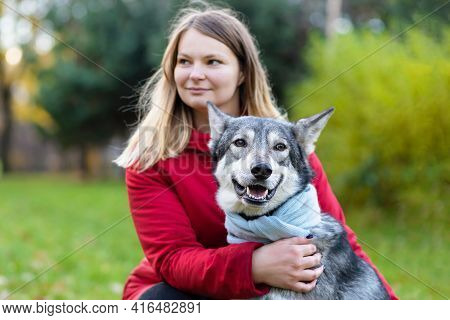 Young Happy Woman Hugging Dog. Pet Adoption.  Czechoslovak With Female Owner. Caucasian Girl Walking