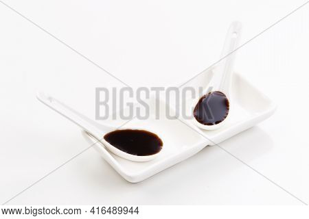 Soy Sauce In Gravy Boat With Spoon On White Background