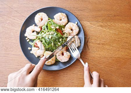 Young Woman At Restaurant Eating Shrimp Salad. Health Food Concept. Fork And Knife. Ountdoor Cafe. H