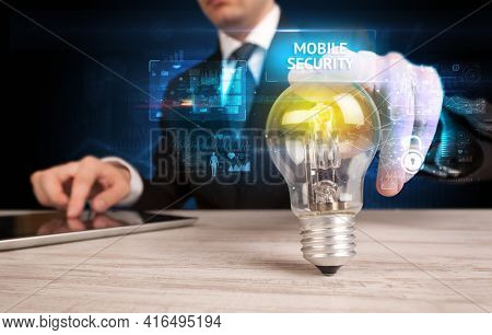 Businessman holding a light bulb, online security concept