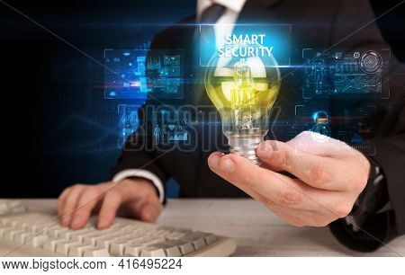 Businessman holding a light bulb, online security concept