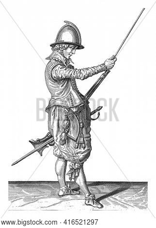Soldier sliding his ramrod into the holder under the course of his rudder, vintage engraving.