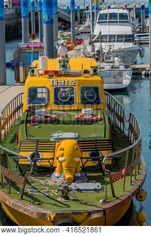 Pyeongtaek, South Korea; April 6, 2021: Yellow Tour Boat With Elephant On Bow Docked At Jeongok Port