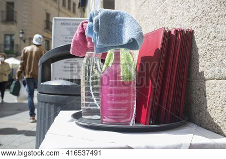 Waiter Tray Full Of Disinfectant Spray Products Over Restaurant Terrace. Covid-19 Measurements In Ho