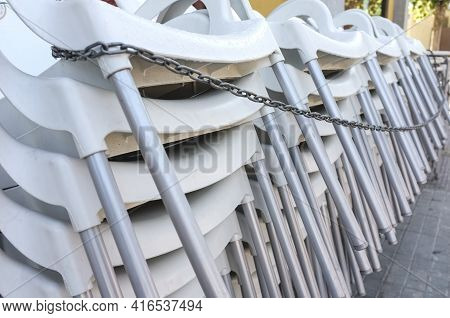 Pilled And Chained Terrace Bar Chairs. Covid-19 Crisis At Hostelry Concept