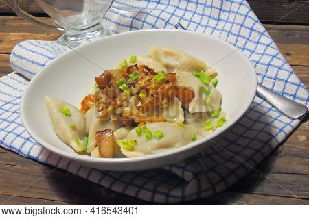 Fried Dumplings Stuffed With Cabbage And Meat Sprinkled With Bacon Greaves And Chopped Parsley On A