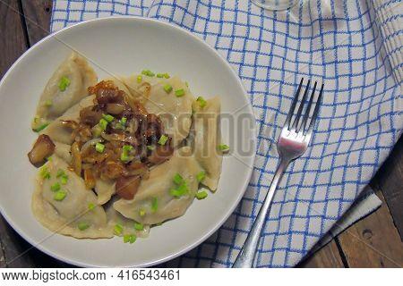 Fried Dumplings Stuffed With Cabbage And Meat Sprinkled With Bacon Greaves And Chopped Parsley On A
