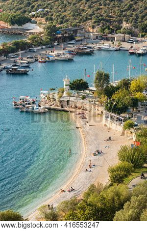 Kalkan, Turkey - November 18, 2020: Small beach and harbor in Kankan resort town in Antalya region, Turkey