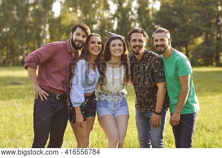 Portrait Of Happy Millennial Friends Looking At Camera In Countryside On Summer Day. Bffs Enjoying W