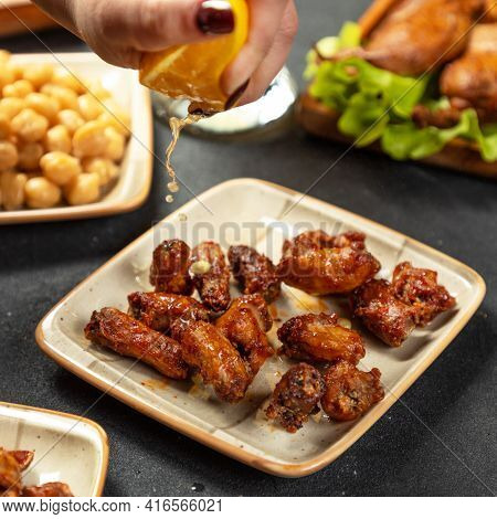 Squeezing Lemon On The Grilled Chicken Meat Dish