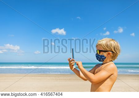 Funny Boy Taking Selfie Photo By Smartphone On Tropical Sea Beach. New Rules To Wear Cloth Face Cove