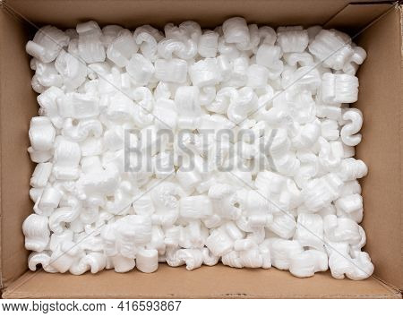 A Cardboard Box With Packing Styro Foam Pellets Top View