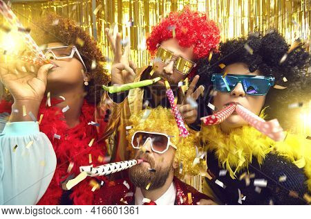 Multiethnic Friends Company In Carnival Wear Blowing In Party Pipes Having Fun