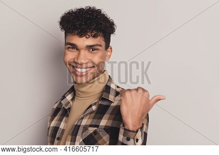 Photo Of Guy Indicate Thumb Empty Space Look Beaming Smile Wear Plaid Shirt Rollneck Isolated Grey C