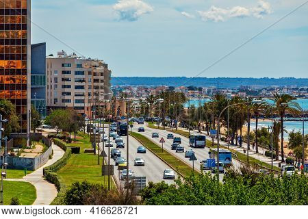 PALMA, SPAIN - MAY 09, 2019: Vehicles drive on urban road along seaside promenade and modern buildings in Palma - capital and largest city of  Balearic Islands, famous resort and tourist destination.