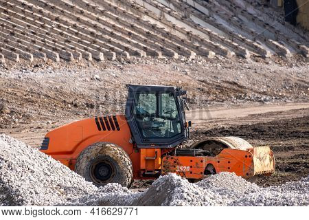 Road Roller Rink Workig To Construction Of A New Highway. Heavy Industrial Machinery Build A Road.