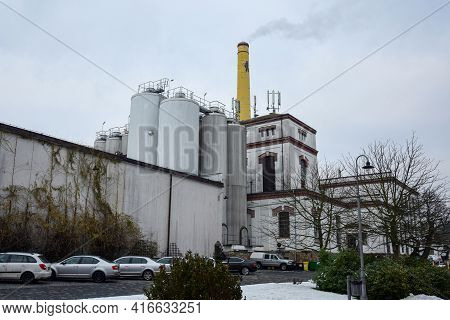 Street View Of The Velkopopovitsky Kozel Brewery With A Yellow Pipe. Velke Popovice. Czech. December