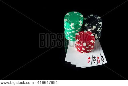 Four Of A Kind Or Quads Cards And Chips In The Black Background. Winning Combination At A Poker Club