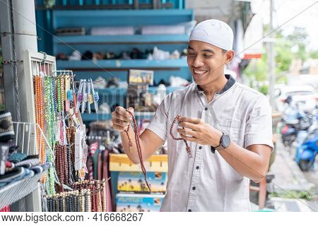 Young Asian Muslim Man Shopping Islamic Beads