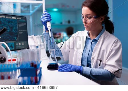 Scientist Using Micropipette To Take Sample To Analyse It