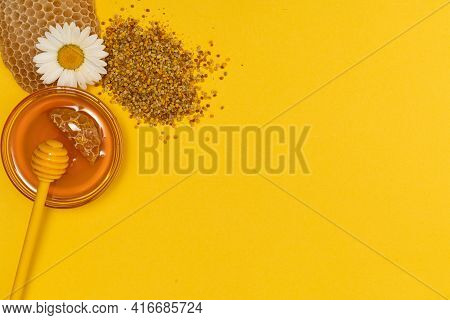 A Yellow Spoon Of Honey Dipped In A Jar Of Honey And Bee Bread Scattered On A Yellow Background Deco