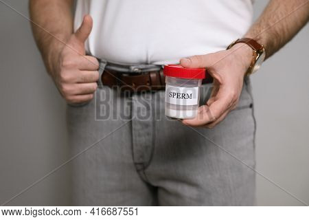 Donor Holding Container With Sperm On Beige Background, Closeup