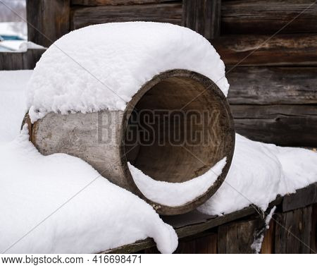 Round Barrel Lies In The Snow In Winter