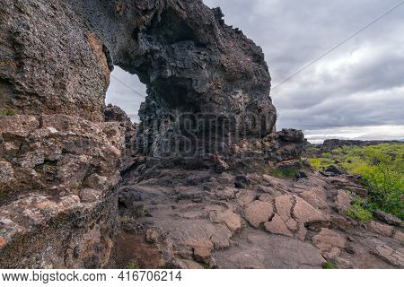 Basalt Arch In The Dimmu Borgir Area Of Northern Iceland. Cold And Cloudy Day In Volcanic Landscape.