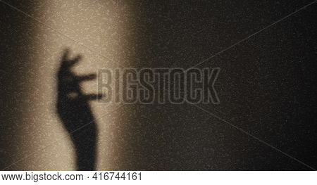 Shadow Of Silhouette Of Female Hand On Gray Background. Elegant Female Hand Shadow In Sunbeam With C