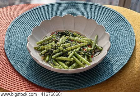 Stir-fried Chinese Morning Glory Or Water Spinach (pak Boong Fai Daeng) Seasoned With Chili And Soy 