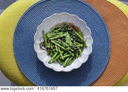 Stir-fried Chinese Morning Glory Or Water Spinach (pak Boong Fai Daeng) Seasoned With Chili And Soy 