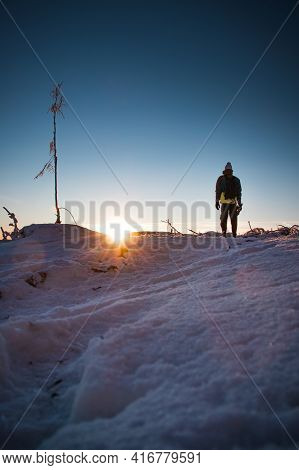 Sunrise In Winter In The Beskydy Mountains In Eastern Bohemia. A Teenager In A Colorful Jacket Stand