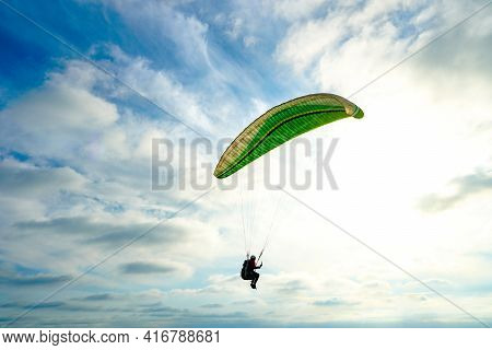 Man Doing Sport, Para-glider In The Clouded Sky. Paragliding Is An Extreme Sport And Recreation. Tor
