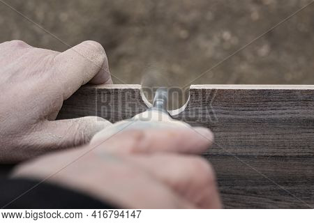 A Man Mills A Hole In A Ceramic Tile For Sanitary Ware With A Mini Electric Sander.renovation And Cl