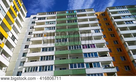 Facade Of New Multicolor Residential Building. Rising Prices For Purchase, Sale And Rental Of Real E