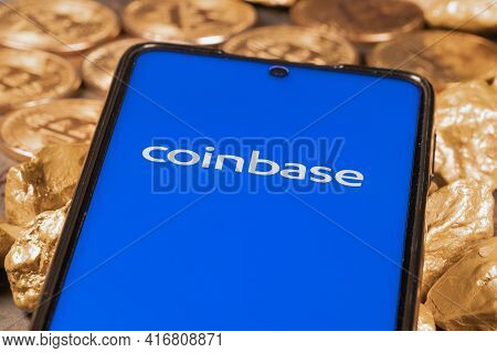 Coinbase Crypto Exchange Logo On Screen With Bitcoin Coins. Ljubljana, Slovenia - April 12 2021