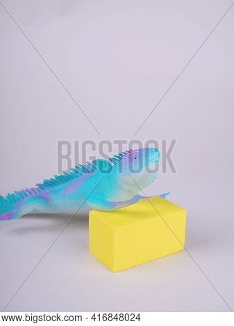 Toy Blue Dinosaur, Lizard, Iguana On A Gray Background