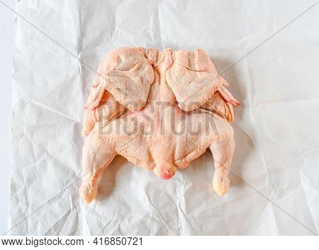 Fresh Raw Whole Chicken Cutting Half For Grill On White Paper. Ingredeint Concept. Top View